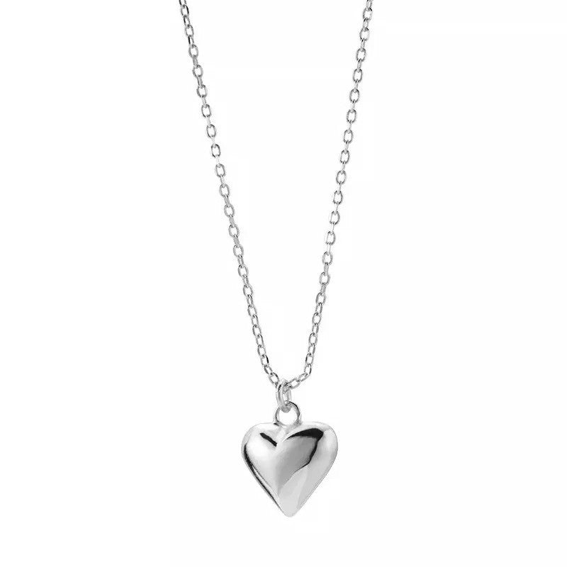 Stelring Silver heart-shaped pendant on a chain against a white background